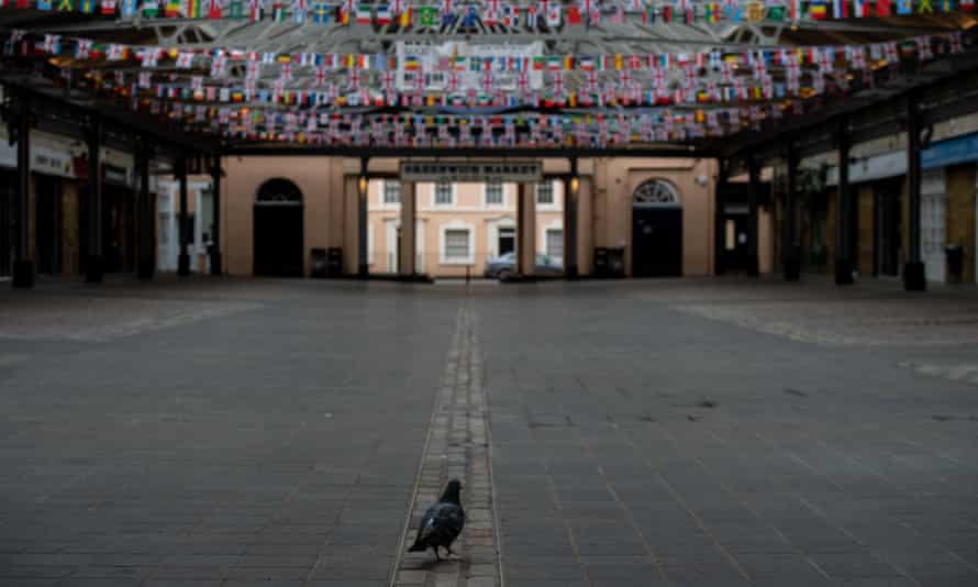 A pigeon crosses a closed and empty Greenwich Market in London on April 28, 2020.