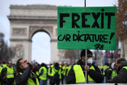 Arc de Triomphe with a protester in a yellow vest carrying a Frexit poster among other yellow vest protesters