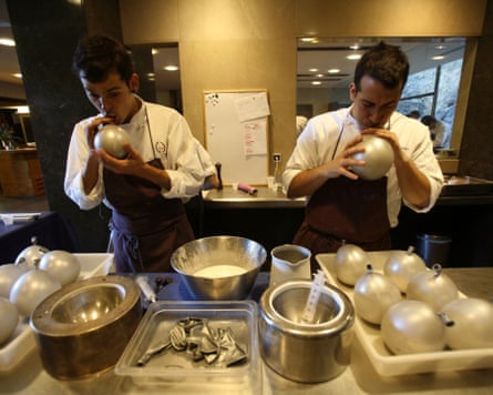 Chefs blow up balloons in the kitchen of the now-closed El Bulli, a pioneer of avant garde Catalan cuisine.