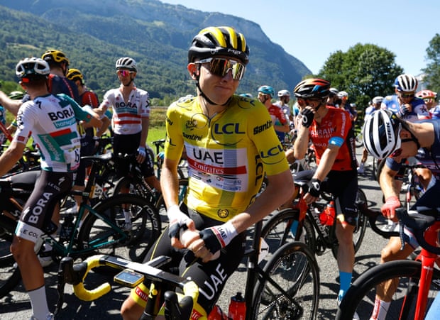 Yellow jersey Tadej Pogacar waits for the race to restart after the protests