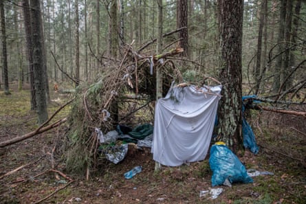 A makeshift hut, shelter for a Syrian family with small children, built with tree branches in the forest near Narewka, Poland.