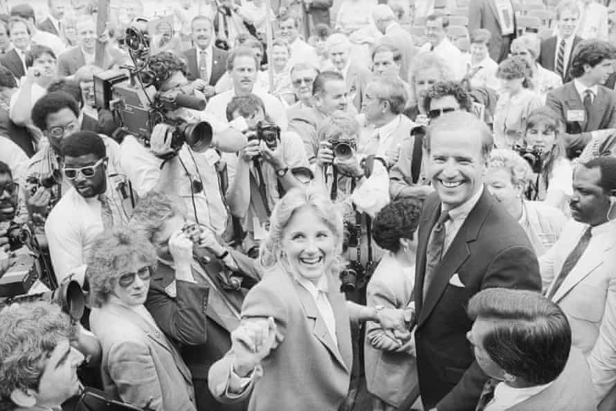 Senator Joseph Biden of Delaware and his wife, Jill, are all smiles as they make their way through a crowd of well-wishers and photographers to take a train to Washington after announcing his candidacy for President of the United States. Biden promised to reawaken the fires of idealism.