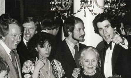 A premiere party for Saturday Night Fever withJohn Travolta, right, next to a bearded Nik Cohn, Travolta’s mother below them, and producer Robert Stigwood (far left).