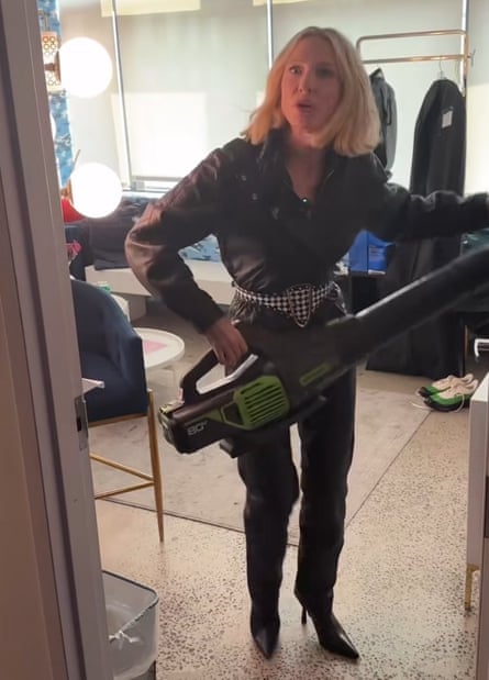Cate Blanchett holding a leaf blower in her dressing room, looking angry.