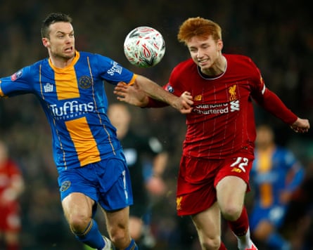 Shaun Whalley of Shrewsbury (left) competes with Sepp van den Berg during his time at Liverpool