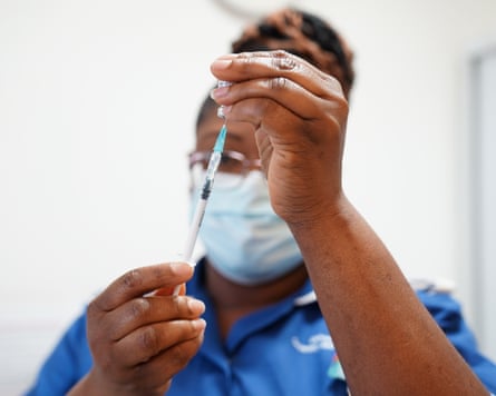 A nurse prepares a dose of a Covid-19 vaccine.