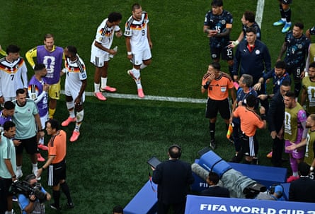 Moroccan referee Jalal Jayed is surrounded by players and unit arsenic he checks nan VAR earlier disallowing Jonathan Tah’s extremity successful other time.