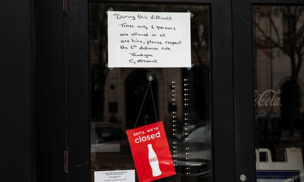 A sign is placed in the window of a restaurant with distancing guidelines as Ohio implements phase one of reopening in Columbus, Ohio, on 1 May.