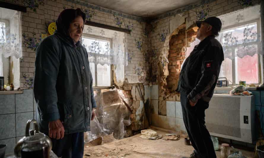 Tanya Los (L), 57, and her husband Valery, stand in their house near damage caused by a rocket, in the village of Mala Tomachka, near the southern front of fighting between Ukrainian and Russian forces, south of Zaporizhzhia, on April 19, 2022.