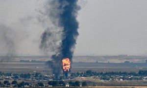 Smoke and fire rise from the Syrian town of Ras al-Ayn in the Turkish offensive against Kurdish groups in north-east Syria in October.