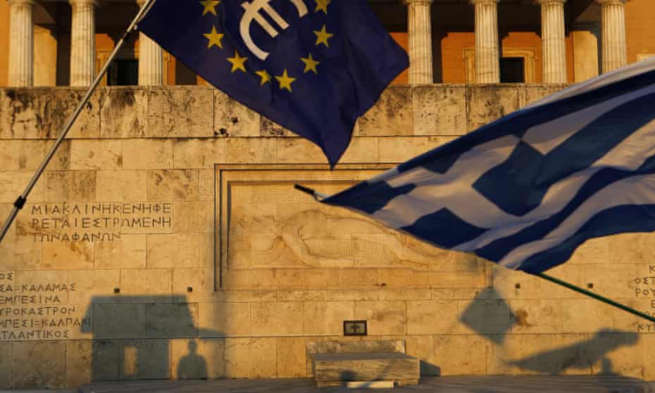 Pro-Euro demonstrators wave a Greek flag and a European Union flag in front of the Tomb of the Unknown Soldier monument in Athens