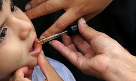 A woman gives a child cannabis oil for medical reasons in Peru, which legalised the substance for medicinal use in 2017