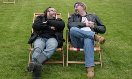 Dave Myers and Si King share a joke while sitting in deckchairs on a lawn