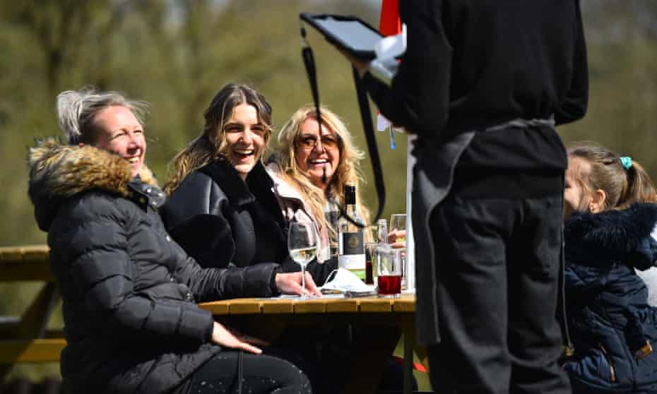 People enjoy a drink in the sun