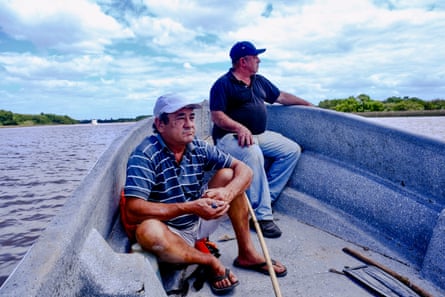 Miguel Galloro (L) and Juan Carlos Garcia (R), on a boat in the Paraná delta