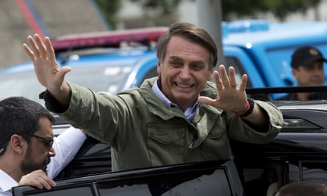 Jair Bolsonaro waves after voting in the presidential runoff election in Rio de Janeiro
