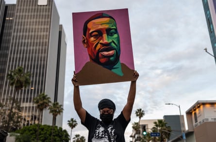 person holds up poster of Floyd