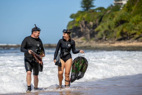 Prof Nick Paul and research assistant Nicole Dare return to shore after harvesting seaweed at Moffat Beach in Caloundra.
