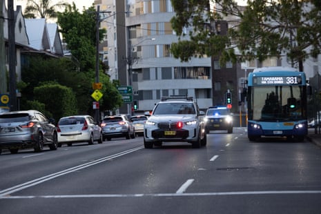 Police travelling down Bondi Road towards Bondi beach after reports of a shooting in the area