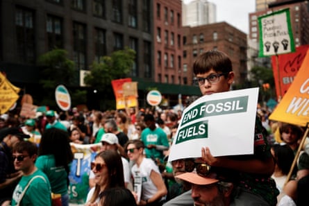 A seven-year-old boy holds a ‘No fossil fuels’ sign at a protest in New York.