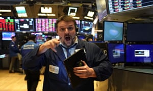 A trader on the floor of the New York Stock Exchange on 9 March, last year, when shares fell almost 8%.
