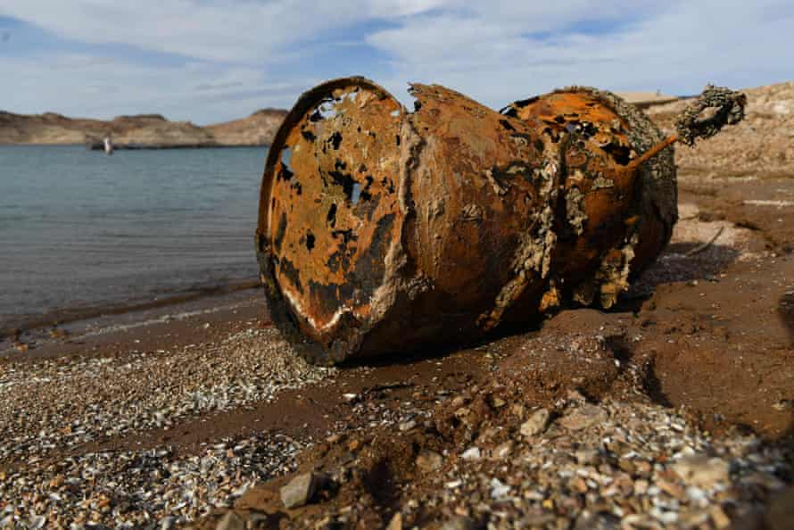 A rusted metal barrel, near the location of where a different barrel was found containing a human body, sits exposed on shore during low water levels due to the western drought at the Lake Mead Marina.