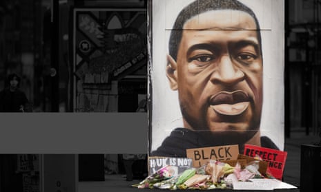 Flowers and tributes surrounding street artist Akse’s mural of George Floyd