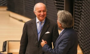 Laurent Fabius speaks to a colleague at the Katowice climate change conference