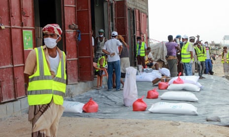 Employees of the World Food Programme (WFP) distribute relief items to displaced Yemenis in the capital Sanaa