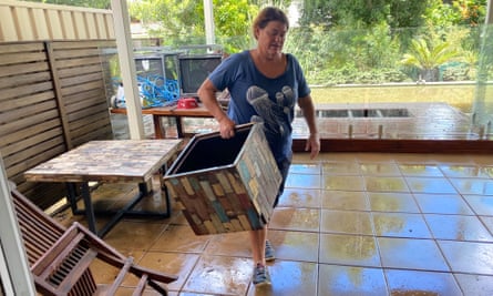 Jenni Metcalfe cleans out her West End home, which had about 1m of water through it on Monday morning at high tide