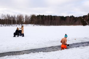 Riga, Latvia
A hairdresser cuts hair on the frozen lake Babelitis while a winter swimmer go swimming in an ice hole.