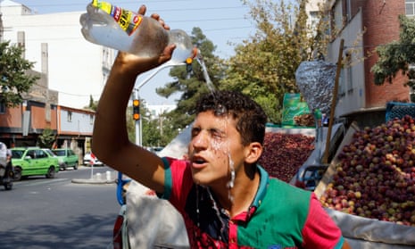 An Iranian street vendor pours water on his face to cool off during a heatwave in Tehran, Iran, 02 August 2015. 