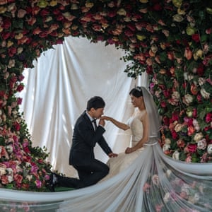 A couple pose at the 27 Rome Brand photo studio