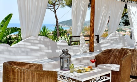 Hotel terrace with white curtains and sea view