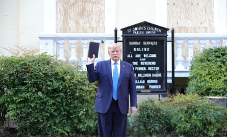 U.S. President Donald Trump holds up a Bible as he stands in front of St. John’s Episcopal Church across from the White House after walking there for a photo opportunity during ongoing protests over racial inequality.