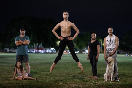 Josue Gomez, a Colombian ballet student, jumps in the air watched by his family.