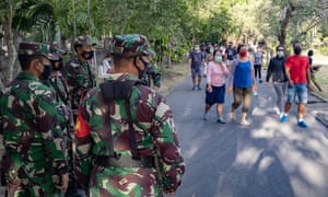 Soldiers check masks in Denpasar, on the island of Bali.