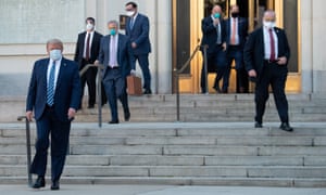 US President Donald Trump walks out of Walter Reed Medical Center in Bethesda, Maryland before heading to Marine One on October 5, 2020, to return to the White House after being discharged.