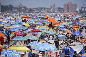 Revellers enjoy the beach in the Brooklyn borough of New York