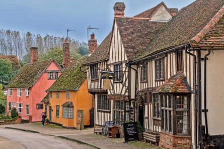 Houses painted traditional ochre and Suffolk pink in the village of Kersey, Suffolk UK.