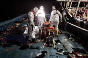 Members of Proactiva Open Arms NGO evacuate a man who died in a stretcher. Many of the vessels were filled with bodies of those who had died on the journey