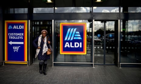 A shopper leaves an Aldi store in London
