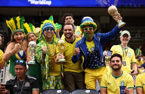 Brazil fans pose for photos as they arrive before the match