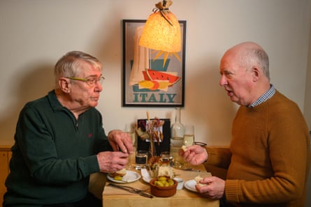 Two men facing each other across a restaurant table