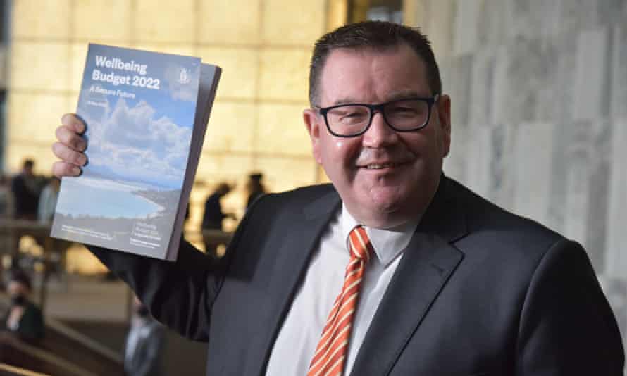 New Zealand finance minister Grant Robertson holds up a copy of the 2022 budget.