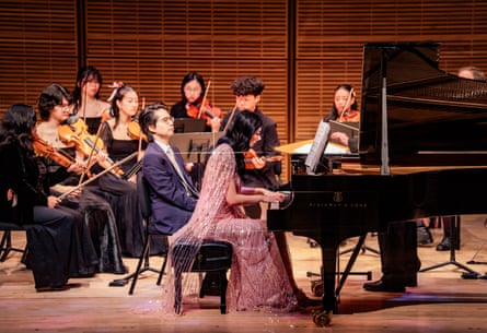 Gene technology entrepreneur Cathy Tie playing the piano, alongside members of the Canadian Sinfonietta Youth Orchestra, at her 30th birthday party at Carnegie Hall, New York, April 2026