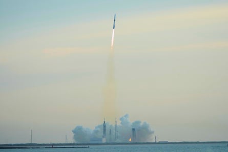 a rocket in the air over water