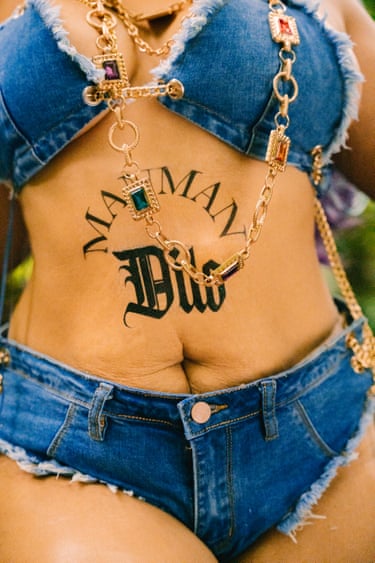 A woman in a denim bikini and gold necklace