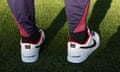 Detailed view of the shoes of Gareth Southgate, manager of England men's senior team, as he inspects the pitch ahead of a press conference at Football Stadium Dortmund. The trainers are embossed with '100' and below 'anything is possible'
