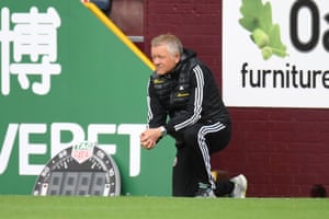 Chris Wilder, takes a knee in support of the Black Lives Matter movement.